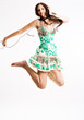 Young female jumping while listening to music