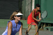 middle aged females playing tennis doubles