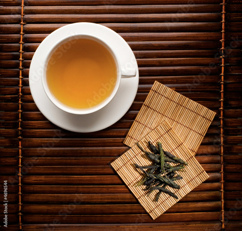 Green tea in a white cup on a dark background