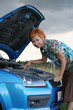 young red-haired woman with her broken car. 