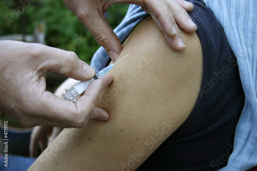 Photo: Doctor holding a needle Doctor holding a needle