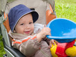 smiling boy in stroller