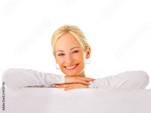 Woman leaning on a billboard