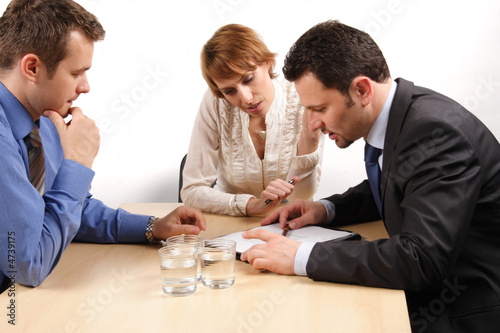Photo: three business people talking about contract three business people talking about contract
