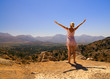 Beautiful girl standing on a mountain with her hands wide open Beautiful girl standing on a mountain with her hands wide open