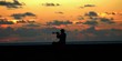 Lonely musician playing at sunset