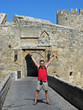 happy tourist in front of old rhodes town happy tourist in front of old rhodes town