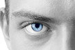 Macro shot of blue man's eye, black and white