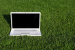 Photo: Laptop on field of green grass Laptop on field of green grass