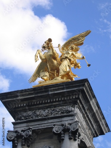 Statues In Paris. Gold statue on the Pont