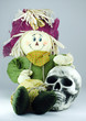 Scarecrow huging human skull