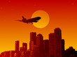 Airplane fly in the sunset in a town