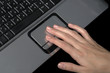 hand over laptop on black