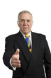older businessman holding hand out to shake hands