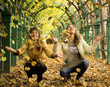 Two girls having in autumn park