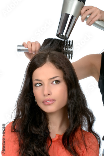 hairdresser is drain a long black hair