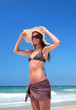 Sexy Woman in Bikini Adjusting hat