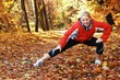 Young, beautiful woman stretching in the park