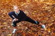 Young, beautiful woman stretching in the park