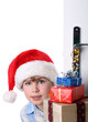 Boy with Santa's Hat peeking behind the door