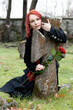 Gothic girl with a rose on a cemetery Gothic girl with a rose on a cemetery