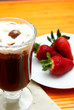 Cup of coffee with strawberries