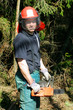 Smiling forestry worker with a chainsaw