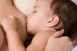 Little kid sleeping and breast-feed
