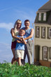 family mother father and child against a background house