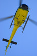 Yellow helicopter in blue sky