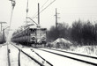Railway track with train in winter. Black and white