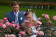 Bride sniffs rose but and bridegroom looks at it