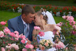 Bridegroom and bride in alley of the roses