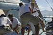 Photo : Sailors Raising Sails During Yacht Race Sailors Raising Sails During Yacht Race