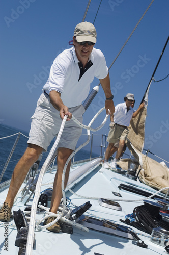 Photo: Sailors on Deck During Yacht Race Sailors on Deck During Yacht Race