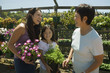 Mother, daughter and grandmother shopping in plant nursery