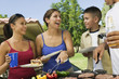 Family Gathered Around Grill