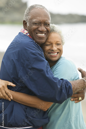 Mature couple embracing on beach