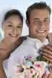 Bride and Groom with bouquet, outdoors, close-up, portrait