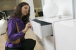 Woman Examining White Dresser drawer in furniture store, close up