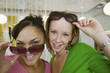 Two Girls Trying on Sunglasses in Boutique, portrait, close up
