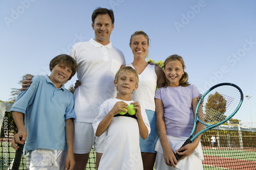 Photo: Family on Tennis Court by net, portrait, front view Family on Tennis Court by net, portrait, front view