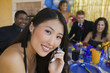 Photo: Well-dressed teenager girl using cell phone at school dance Well-dressed teenager girl using cell phone at school dance