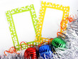 two photoframes with decorative balls and tinsel