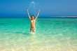 happy brunette playing with wather on the beach of red sea happy brunette playing with wather on the beach of red sea