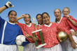 Girls' soccer team 13-17 holding trophy and celebrating, portrait