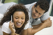 Couple lying on yacht, woman talking on mobile phone