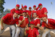 Baseball team-mates holding trophy on field