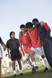 Team-mates carrying injured soccer player