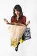 Woman with green yellow and beige shopping bags Woman with green yellow and beige shopping bags